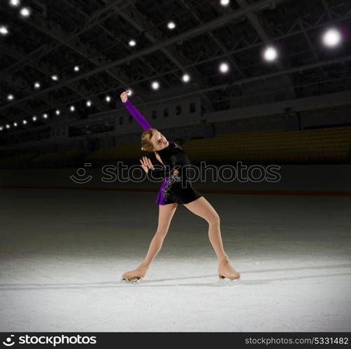 Young woman figure skater at sports hall