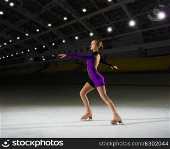 Young woman figure skater at sports hall