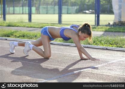 young woman finaly passing finis line at athletics running race track
