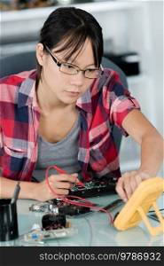 young woman fix pc component in service center