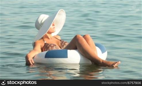 young woman floating in inner tube