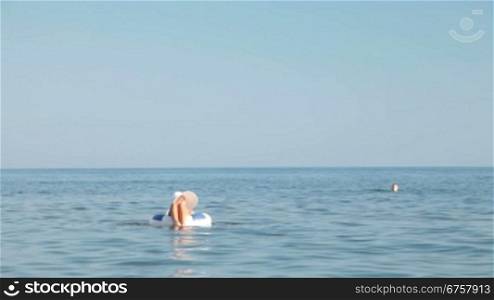 young woman floating on inner tube