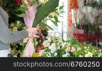 Young Woman Florist Making Alstroemeria Bouquet In Flower Shop