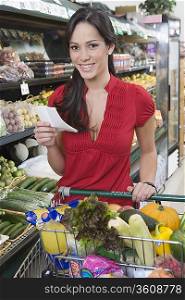 Young woman food shopping in supermarket