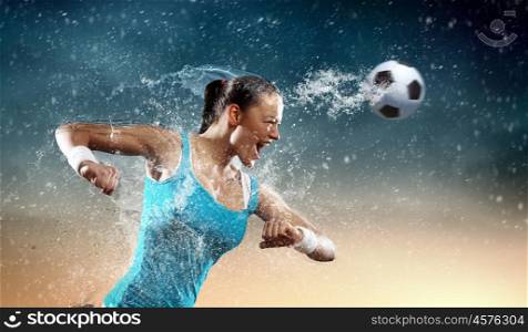 Young woman football player. Image of young woman football player hitting ball