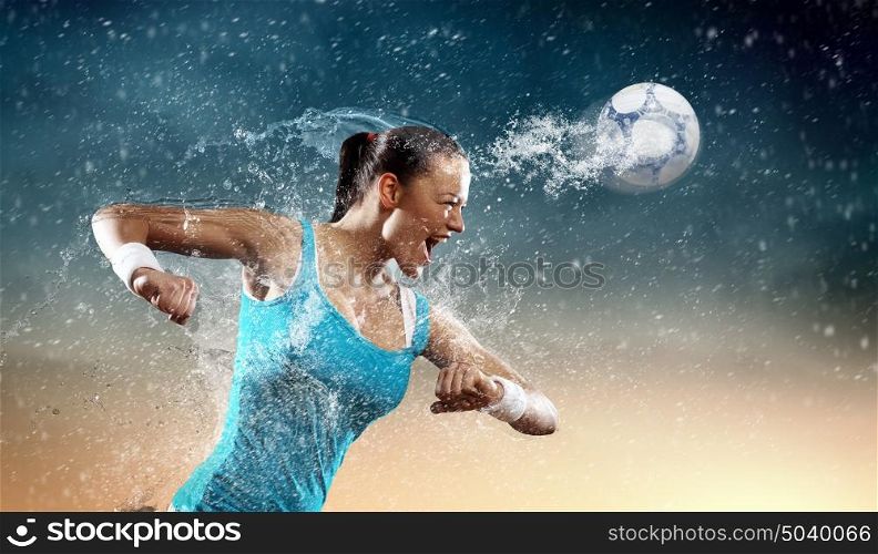 Young woman football player. Image of young woman football player hitting ball