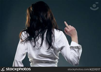 young woman from back showing the finger. young woman from back showing the middle finger