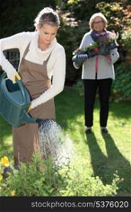 Young woman gardening with her grandmother