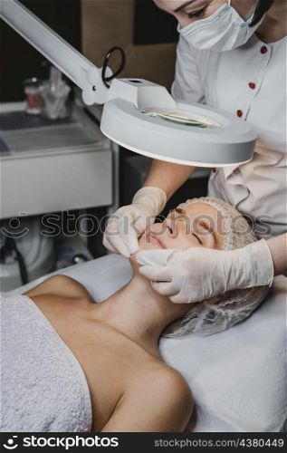 young woman getting beauty procedure spa