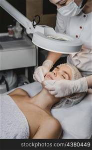 young woman getting beauty procedure spa