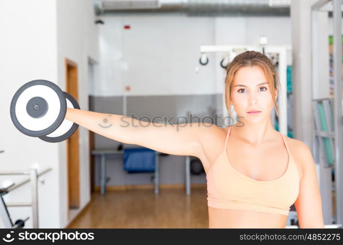 Young woman getting into shape at the gym