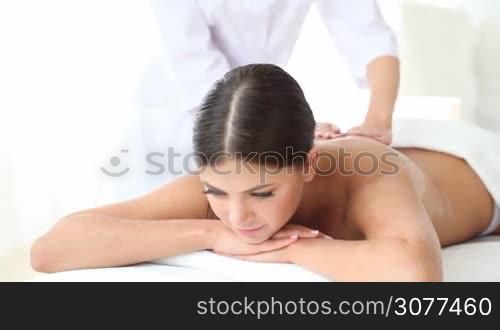 Young woman getting massage at spa session