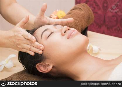 Young woman getting thai massage in spa