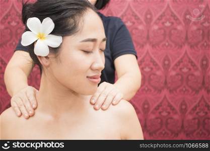 Young woman getting thai massage in spa