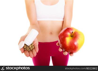 Young woman girl holding pills and apple. Choice between synthetic vitamins natural. Health care. Healthy lifestyle nutrition concept. Isolated on white background.