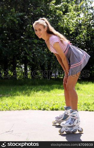 young woman goes for a drive in park on the roller fads