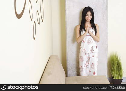 Young woman greeting with her eyes closed