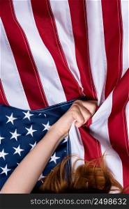Young woman hand pull USA american flag concept top view 