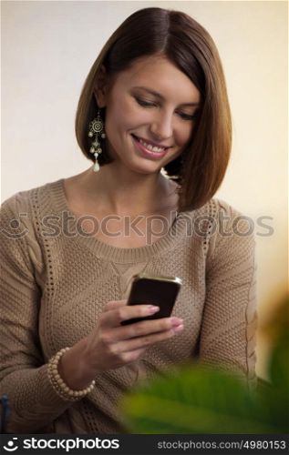 Young woman handing smartphone