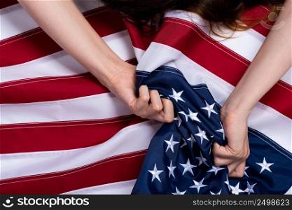 Young woman hands pulling USA american flag sex orgasm sign concept