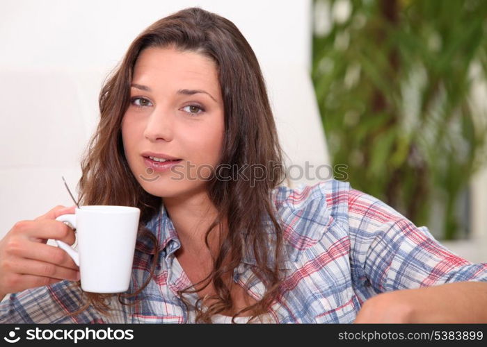 Young woman having a hot drink