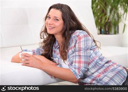 Young woman having a hot drink