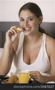 Young woman having breakfast and smiling