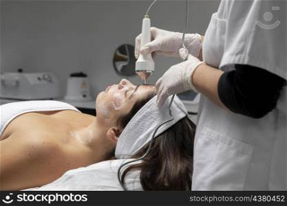 young woman having facial treatment