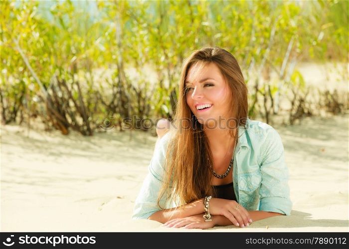 Young woman having fun in summer vacation holidays, female model lying outdoor on sandy beach grassy dune