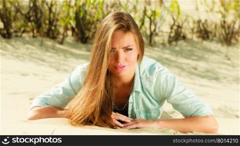 Young woman having fun in summer vacation holidays, female model lying outdoor on sandy beach grassy dune