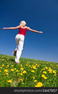 young woman having fun on a flowery meadow