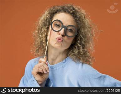 young woman having fun with fake glasses