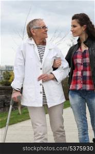Young woman helping elderly person