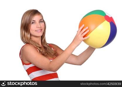 young woman holding a beach ball