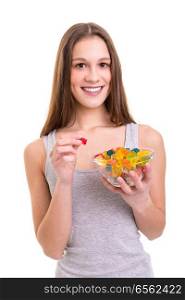 Young woman holding a bowl of jelly gummy bears, isolated over white background