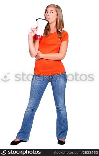 Young woman holding a bullhorn standing in front of white background