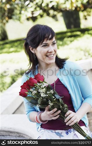 Young woman holding a bunch of roses