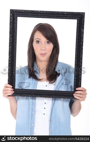 young woman holding a frame
