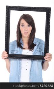 young woman holding a frame