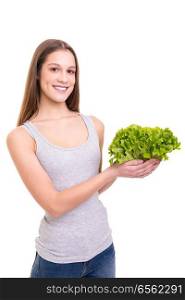 Young woman holding a fresh lettuce, isolated over white background