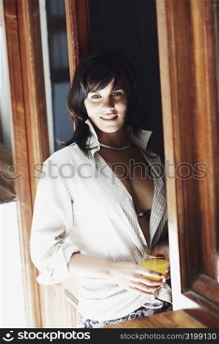 Young woman holding a glass of white wine and smiling