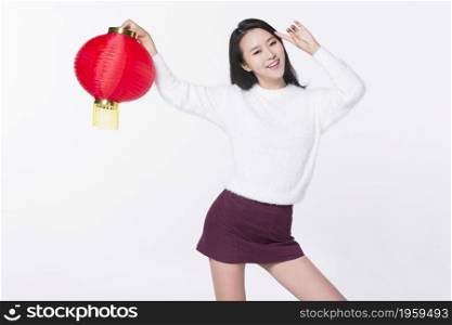 Young woman holding a lantern to celebrate the new year