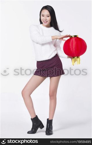 Young woman holding a lantern to celebrate the new year