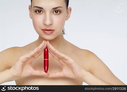 Young woman holding a lipstick