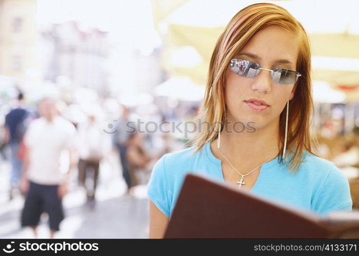 Young woman holding a menu