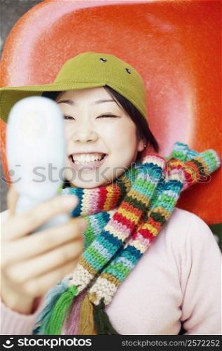 Young woman holding a mobile phone