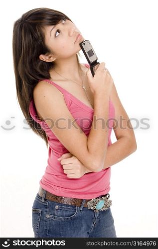 Young woman holding a mobile phone and thinking