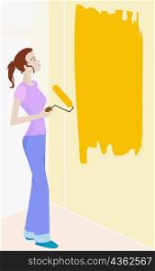Young woman holding a paint roller in front of a wall