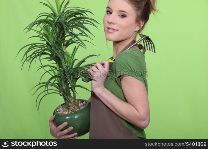 Young woman holding a plant