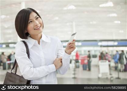 Young Woman Holding an Airplane Ticket